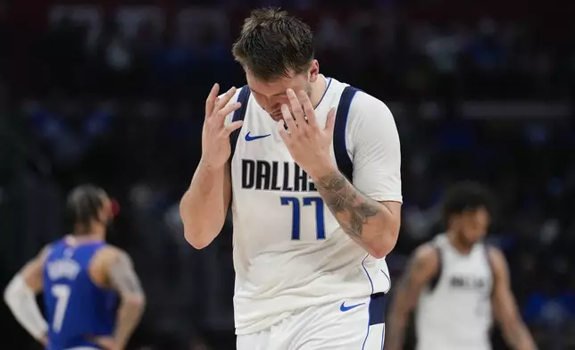 Dallas Mavericks guard Luka Doncic (77) reacts after a foul call during the second half of Game 1 of an NBA basketball first-round playoff series against the LA Clippers in Los Angeles, Sunday, April 21, 2024. (AP Photo/Ashley Landis)