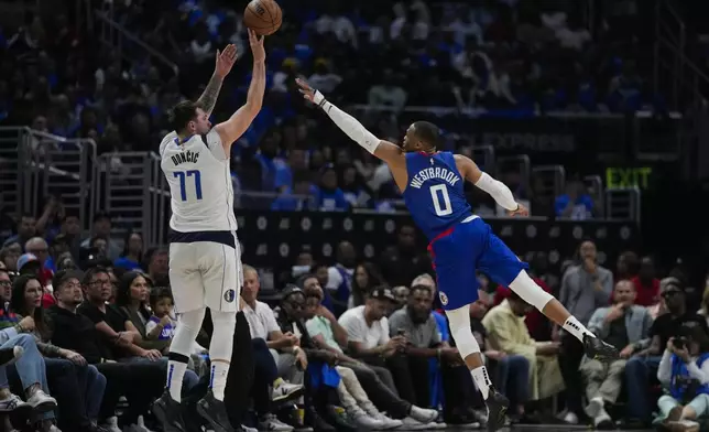 Dallas Mavericks guard Luka Doncic (77) shoots against LA Clippers guard Russell Westbrook (0) during the second half of Game 1 of an NBA basketball first-round playoff series in Los Angeles, Sunday, April 21, 2024. (AP Photo/Ashley Landis)