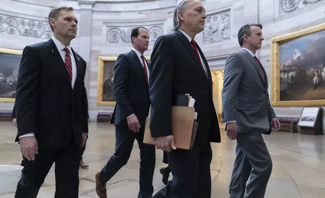 House Impeachment Managers from left, Rep. Michael Guest, R-Miss., Rep. August Pfluger, R-Texas, Rep. Andy Biggs, R-Ariz., and Rep. Ben Cline, R-Va., walk cross the Capitol Rotunda to the Senate chamber to deliver Homeland Security Secretary Alejandro Mayorkas Impeachment Articles at the Capitol in Washington, Tuesday, April 16, 2024. (AP Photo/Jose Luis Magana)