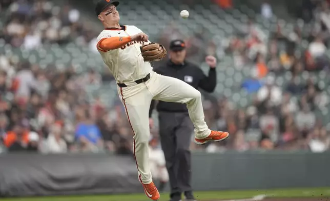 San Francisco Giants third baseman Matt Chapman throws to first base on a single hit by New York Mets' Francisco Lindor during the first inning of a baseball game in San Francisco, Wednesday, April 24, 2024. (AP Photo/Jeff Chiu)