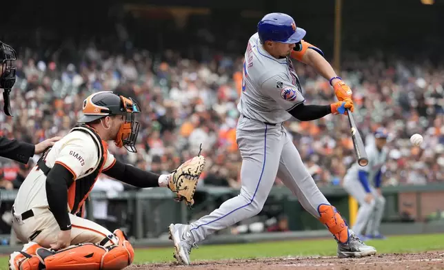 New York Mets' Tyrone Taylor, right, hits a two-run double in front of San Francisco Giants catcher Patrick Bailey during the fifth inning of a baseball game in San Francisco, Wednesday, April 24, 2024. (AP Photo/Jeff Chiu)