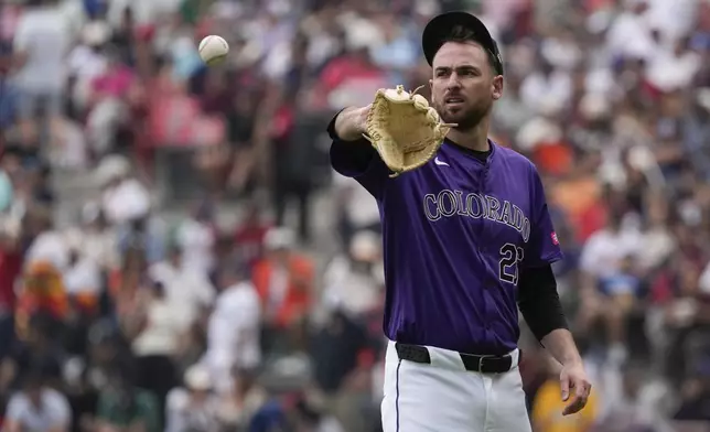 Colorado Rockies starting pitcher Austin Gomber recieves the ball during third inning of a baseball game against the Houston Astros at Alfredo Harp Helu stadium in Mexico City, Sunday, April 28, 2024. (AP Photo/Fernando Llano)
