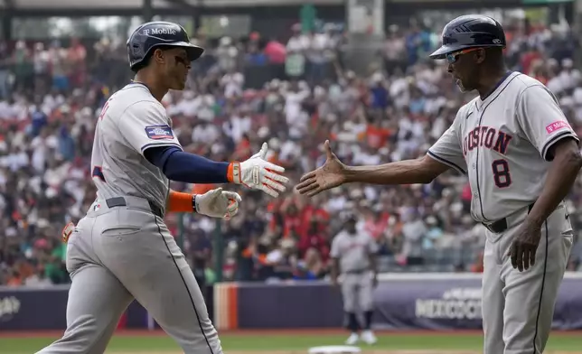 Houston Astros shortstop Jeremy Peña, left, runs the bases after hitting a solo home run against the Colorado Rockies during fourth inning of a baseball game at Alfredo Harp Helu stadium in Mexico City, Sunday, April 28, 2024. (AP Photo/Fernando Llano)