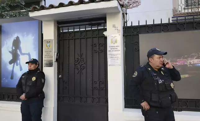 Mexican police stand guard outside the Ecuadorian Embassy, in Mexico City, Saturday, April 6, 2024. The Mexican president moved to break off diplomatic ties with Ecuador after police broke into the Mexican Embassy in Quito to arrest a former vice president who had sought political asylum there after being indicted on corruption charges. (AP Photo/Ginnette Riquelme)