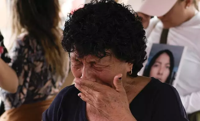 Cecilia Gonzalez, the mother of Amarirany Roblero, who went missing 12 years ago, cries during a protest outside an apartment rented by a suspected serial killer where evidence related to her daughter was found, in the Iztacalco neighborhood of Mexico City, Friday, April 26, 2024. Protesters covered the facade of the building with placards after investigators found the bones, cell phones and ID cards of several women at rented rooms there, asking variants of a single question: Why did it take prosecutors 12 years to investigate the disappearance of Amairany Roblero, then 18. (AP Photo/Marco Ugarte)