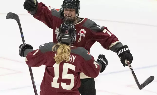 Montreal's Laura Stacey (7) celebrates her tying goal against Minnesota with Maureen Murphy (15) during the third period of a PWHL hockey game Thursday, April 18, 2024, in Montreal. (Christinne Muschi/The Canadian Press via AP)