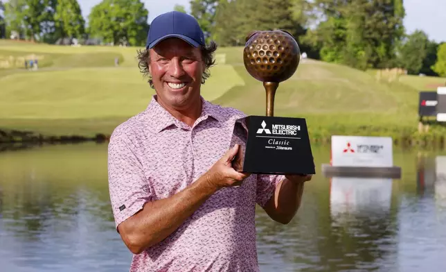 Stephen Ames shows the trophy to the media after winning the Mitsubishi Classic senior golf tournament at TPC Sugarloaf on Sunday, April 28, 2024, in Duluth, Ga. (Miguel Martinez/Atlanta Journal-Constitution via AP)