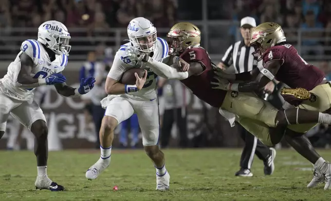 FILE - Duke quarterback Riley Leonard (13) is tackled by Florida State defensive lineman Jared Verse (5) after scrambling for yardage during the first half of an NCAA college football game, Saturday, Oct. 21, 2023, in Tallahassee, Fla. Verse is a possible first round pick in the NFL Draft. (AP Photo/Phelan M. Ebenhack, File)