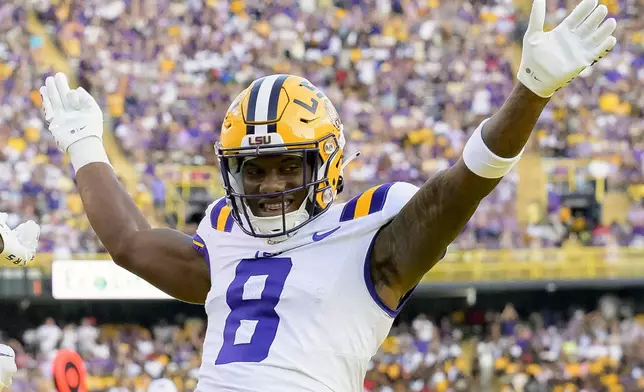 FILE - LSU wide receiver Malik Nabers (8) celebrates after a touchdown by teammate Brian Thomas Jr. against Grambling State during an NCAA college football game in Baton Rouge, La., Saturday, Sept. 9, 2023. Nabers is a possible first round pick in the NFL Draft.(AP Photo/Matthew Hinton, File)