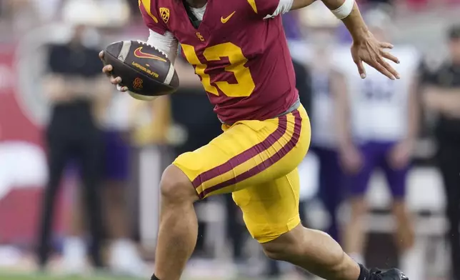 FILE - Southern California quarterback Caleb Williams (13) runs during the first half of an NCAA college football game against Washington Saturday, Nov. 4, 2023, in Los Angeles. Williams is expected to be taken in the first round of the NFL Draft. (AP Photo/Marcio Jose Sanchez, File)