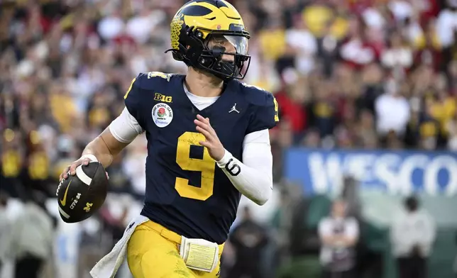FILE - Michigan quarterback J.J. McCarthy (9) rolls out during the second half of the Rose Bowl CFP NCAA semifinal college football game against Alabama Monday, Jan. 1, 2024, in Pasadena, Calif. McCarthy is a possible first round pick in the NFL Draft.(AP Photo/Kyusung Gong, File)
