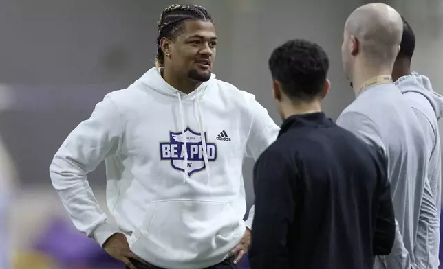 FILE - Washington wide receiver Rome Odunze talks while standing on the field during Washington's NFL Pro Day, Thursday, March 28, 2024, in Seattle. Odunze is a possible first round pick in the NFL Draft.(AP Photo/John Froschauer, File)