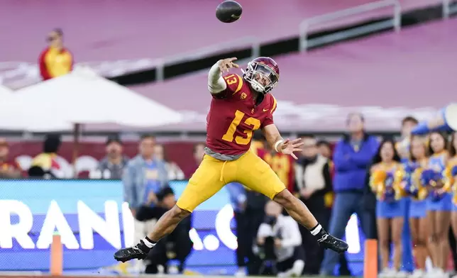 FILE - Southern California quarterback Caleb Williams throws a pass during the second half of the team's NCAA college football game against UCLA, Saturday, Nov. 18, 2023, in Los Angeles. Williams is expected to be taken in the first round of the NFL Draft. (AP Photo/Ryan Sun, File)