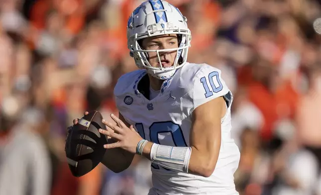 FILE - North Carolina quarterback Drake Maye (10) plays during the first half of an NCAA college football game Saturday, Nov. 18, 2023, in Clemson, S.C. Maye is a possible first round pick in the NFL Draft. (AP Photo/Jacob Kupferman, File)