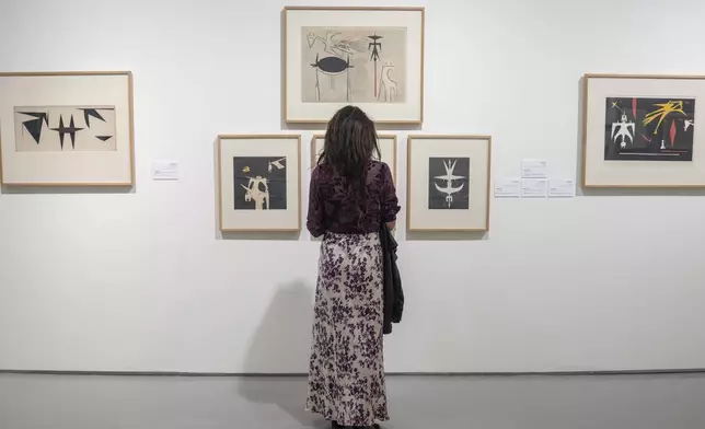 A visitor observes artwork by Afro-Cuban painter Wifredo Lam at the Mohammed VI Museum of Modern and Contemporary Art in Rabat, Monday, April 1, 2024. A show at Morocco's Mohammed VI Museum of Modern and Contemporary Art is one of the first exhibitions of Cuban art at an African museum. (AP Photo/Mosa'ab Elshamy)