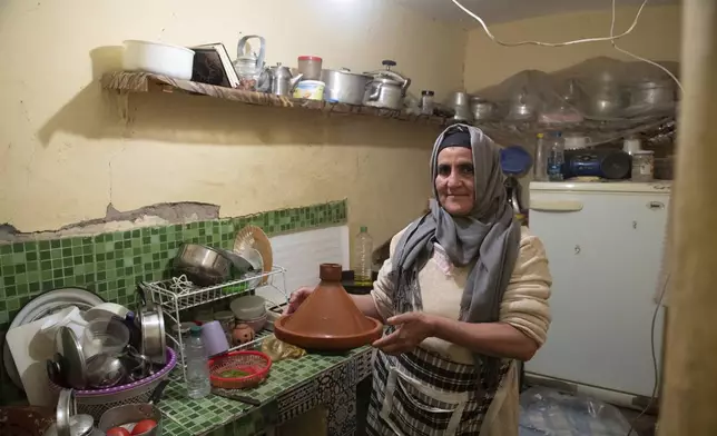 Fatima Barri, 57, prepares food to break her Ramadan fast in her home which was damaged by the earthquake last year, in Amizmiz, near Marrakech, Thursday, April 4, 2024. (AP Photo)