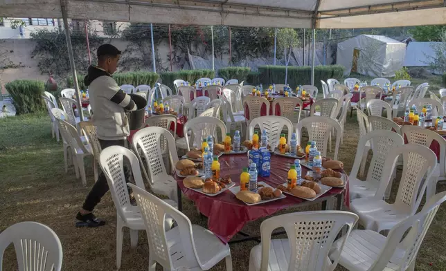 People who have been displaced by the earthquake prepare to host a group Iftar to break their Ramadan fast, in Amizmiz, near Marrakech, Thursday, April 4, 2024. (AP Photo)