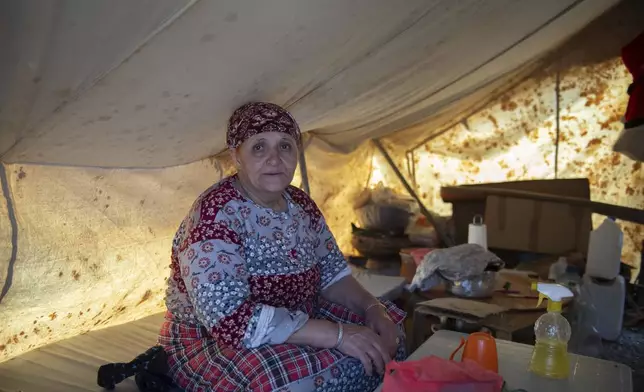 Khadija, a woman was was displaced by the earthquake prepares for Iftar to break her Ramadan fast in her tent, in Amizmiz, near Marrakech, Thursday, April 4, 2024. (AP Photo)