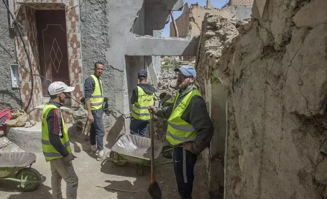 Workers clear the rubble left after the earthquake in Amizmiz, near Marrakech, Thursday, April 4, 2024. (AP Photo)