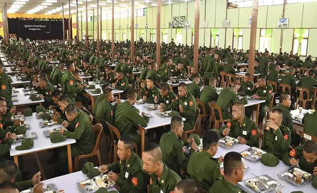 In this undated photo released on April 8, 2024, by The Military True News Information Team, trainees of first batch of military service have meals as an opening ceremony for their training session was held at a military compound in Yangon, Myanmar. Myanmar’s military has begun basic training at military bases and schools across the country for draftees called up under the country’s recently activated conscription law, state-run media reported on Tuesday, April 9.(The Military True News Information Team via AP)