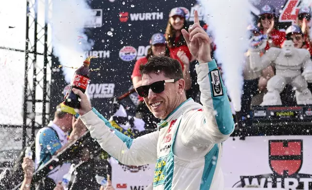 Denny Hamlin celebrates in Victory Lane after winning a NASCAR Cup Series auto race at Dover Motor Speedway, Sunday, April 28, 2024, in Dover, Del. (AP Photo/Derik Hamilton)