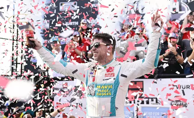 Denny Hamlin celebrates in Victory Lane after winning a NASCAR Cup Series auto race at Dover Motor Speedway, Sunday, April 28, 2024, in Dover, Del. (AP Photo/Derik Hamilton)