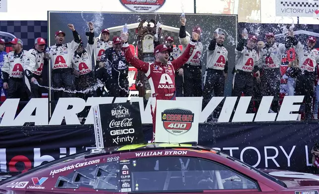 William Byron celebrates in Victory Lane after winning a NASCAR Cup Series auto race at Martinsville Speedway in Martinsville, Va., Sunday, April 7, 2024. (AP Photo/Chuck Burton)