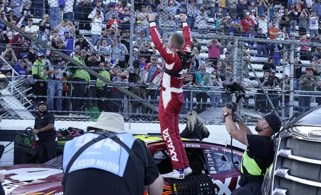 William Byron celebrates after winning a NASCAR Cup Series auto race at Martinsville Speedway in Martinsville, Va., Sunday, April 7, 2024. (AP Photo/Chuck Burton)