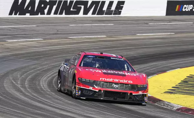 Chase Briscoe (14) drives out of Turn 4 during a NASCAR Cup Series auto race at Martinsville Speedway in Martinsville, Va., Sunday, April 7, 2024. (AP Photo/Chuck Burton)