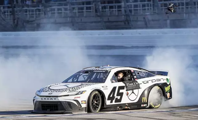 Tyler Reddick celebrates his win after a NASCAR Cup Series auto race at Talladega Superspeedway, Sunday, April 21, 2024, in Talladega. Ala. (AP Photo/Mike Stewart)