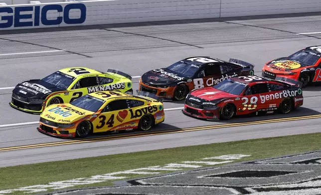 NASCAR driver's Michael McDowell (34), Austin Cindric (2) and Todd Gilliland (38) during a NASCAR Cup Series auto race at Talladega Superspeedway, Sunday, April 21, 2024, in Talladega. Ala. (AP Photo/Butch Dill)