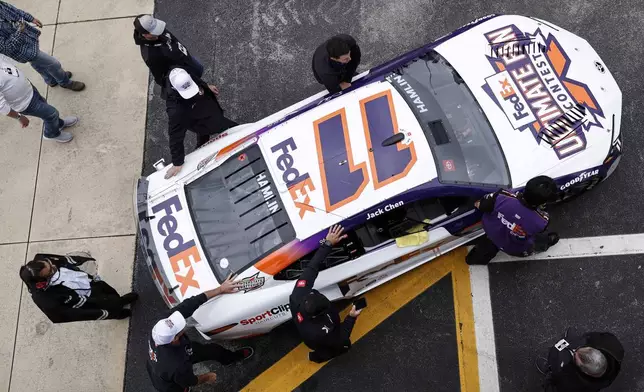 NASCAR Cup Series driver Denny Hamlin's car is moved before a NASCAR Cup Series auto race at Talladega Superspeedway, Sunday, April 21, 2024, in Talladega. Ala. (AP Photo/Butch Dill)