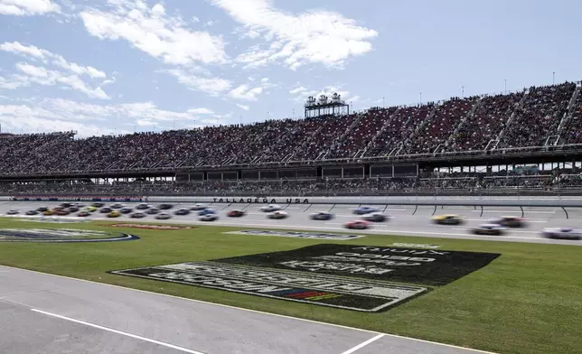 Cars move during a NASCAR Cup Series auto race at Talladega Superspeedway, Sunday, April 21, 2024, in Talladega. Ala. (AP Photo/Butch Dill)