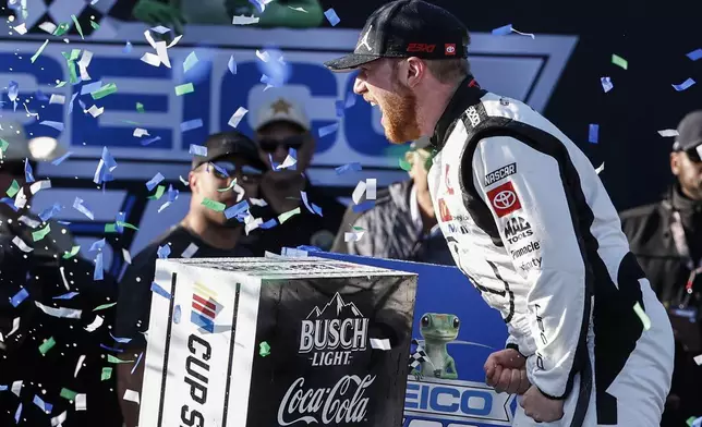 Tyler Reddick celebrates his win at a NASCAR Cup Series auto race at Talladega Superspeedway, Sunday, April 21, 2024, in Talladega. Ala. (AP Photo/Butch Dill)