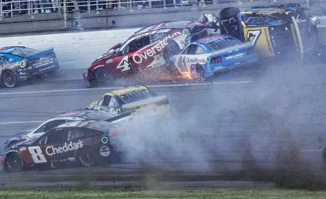 NASCAR Cup Series driver's Ryan Preece (41) Josh Berry (4) and Corey LaJoie (7) crash on the final lap during a NASCAR Cup Series auto race at Talladega Superspeedway, Sunday, April 21, 2024, in Talladega. Ala. (AP Photo/Butch Dill)