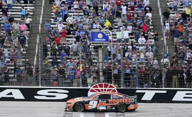 Chase Elliott crosses the finish line to win a NASCAR Cup Series auto race at Texas Motor Speedway in Fort Worth, Texas, Sunday, April 14, 2024. (AP Photo/Larry Papke)