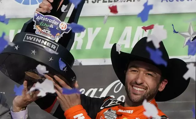 Chase Elliott celebrates with the trophy after winning a NASCAR Cup Series auto race at Texas Motor Speedway in Fort Worth, Texas, Sunday, April 14, 2024. (AP Photo/Larry Papke)