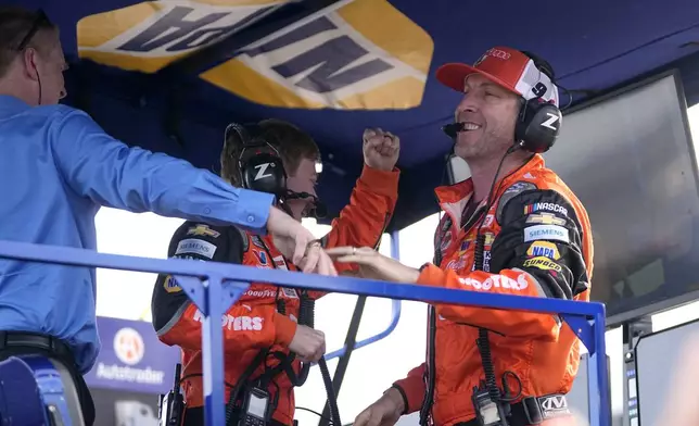Chase Elliott's crew chief Alan Gustafson, right, celebrates with team members after winning a NASCAR Cup Series auto race at Texas Motor Speedway in Fort Worth, Texas, Sunday, April 14, 2024. (AP Photo/Tony Gutierrez)