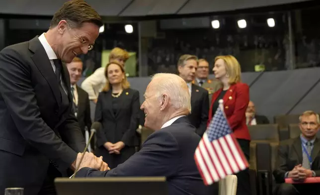 FILE - U.S. President Joe Biden, center, greets Netherland's Prime Minister Mark Rutte, left, prior to a round table meeting during an extraordinary NATO summit at NATO headquarters in Brussels, Thursday, March 24, 2022. NATO is set to celebrate on Thursday, April 4, 2024, 75 years of collective defense across Europe and North America as Russia's war on Ukraine enters its third year. (AP Photo/Markus Schreiber, File)