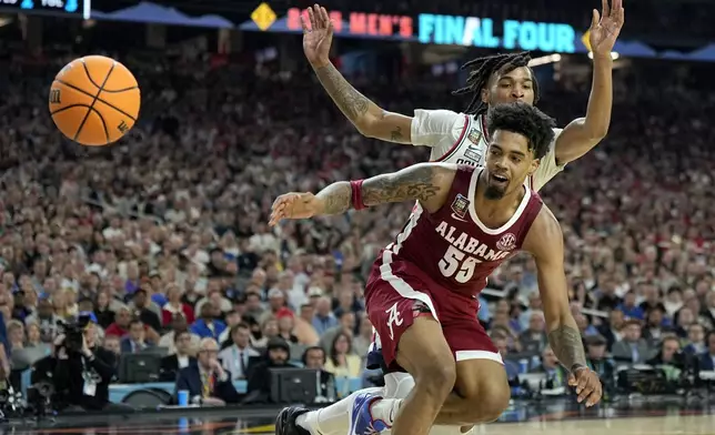 Alabama guard Aaron Estrada (55) watches the ball fall out of bounds as UConn guard Stephon Castle defends during the second half of the NCAA college basketball game at the Final Four, Saturday, April 6, 2024, in Glendale, Ariz. (AP Photo/Brynn Anderson )