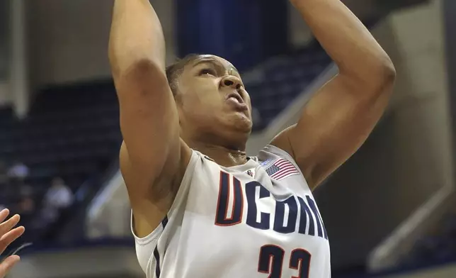 FILE - Connecticut's Maya Moore drives to the basket while guarded by Indiana of Pennsylvania's Brianna Johnson during the first half of an NCAA college exhibition basketball game in Hartford, Conn., Wednesday, Nov. 10, 2010. UConn had two straight undefeated seasons that were a huge part of their 90-game winning streak that broke the UCLA men's record for consecutive victories. The Huskies were led by the superstar trio of Maya Moore, Renee Montgomery and Tina Charles, who combined to average over 50 points a game in 2009. (AP Photo/Jessica Hill, File)