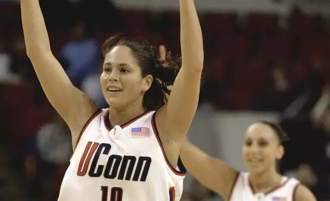 FILE - Connecticut's Sue Bird (10) and teammate Diana Taurasi (3) signal another teammate's three-point score during the first half against Old Dominion in the NCAA Mideast Regional championship game in Milwaukee, Monday, March 25, 2002. This was the beginning of a run of three straight national championships for the Huskies. The team had a star-studded lineup that included five future pros in Sue Bird, Diana Taurasi, Swin Cash, Tamika Williams and Asjha Jones. (AP Photo/Jeffrey Phelps, File)