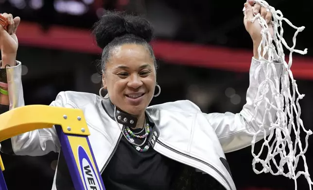 South Carolina head coach Dawn Staley cuts down the net after the Final Four college basketball championship game against Iowa in the women's NCAA Tournament, Sunday, April 7, 2024, in Cleveland. South Carolina won 87-75. (AP Photo/Morry Gash)