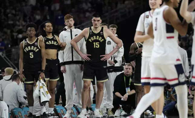 Purdue center Zach Edey (15) watches as UConn celebrates their win in the NCAA college Final Four championship basketball game, Monday, April 8, 2024, in Glendale, Ariz. (AP Photo/David J. Phillip)