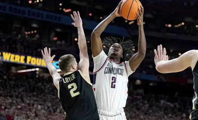 UConn guard Tristen Newton, right, is fouled by Purdue guard Fletcher Loyer during the first half of the NCAA college Final Four championship basketball game, Monday, April 8, 2024, in Glendale, Ariz. (AP Photo/Brynn Anderson)