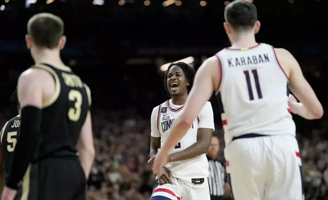 UConn guard Tristen Newton (2) celebrates after scoring against Purdue during the second half of the NCAA college Final Four championship basketball game, Monday, April 8, 2024, in Glendale, Ariz. (AP Photo/David J. Phillip)