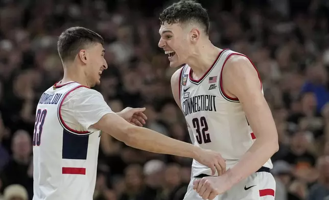 UConn center Donovan Clingan (32) celebrates with guard Apostolos Roumoglou (33) after their win against Purdue in the NCAA college Final Four championship basketball game, Monday, April 8, 2024, in Glendale, Ariz. (AP Photo/David J. Phillip)