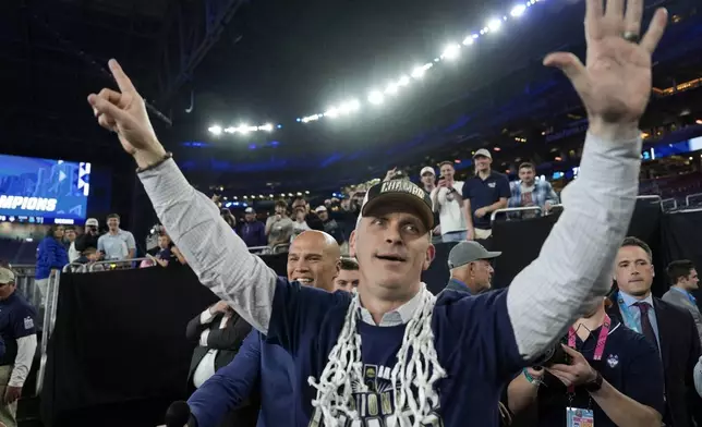 UConn head coach Dan Hurley greets fans after their win against Purdue in the NCAA college Final Four championship basketball game, Monday, April 8, 2024, in Glendale, Ariz. (AP Photo/David J. Phillip)