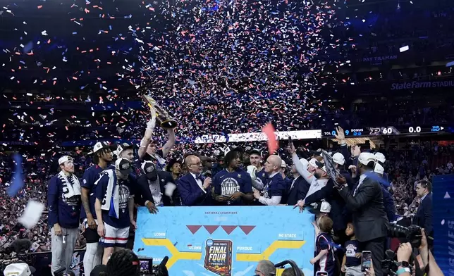UConn players celebrate after the NCAA college Final Four championship basketball game against Purdue, Monday, April 8, 2024, in Glendale, Ariz. (AP Photo/Brynn Anderson)