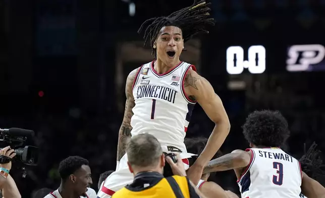 UConn guard Solomon Ball (1) celebrates as time expires during the second half of the NCAA college Final Four championship basketball game against Purdue, Monday, April 8, 2024, in Glendale, Ariz. (AP Photo/Brynn Anderson)